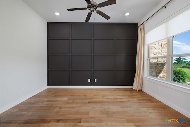 empty room featuring ceiling fan and light hardwood / wood-style floors