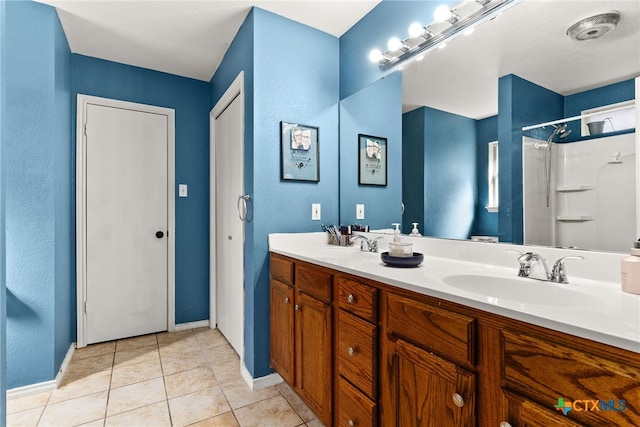 bathroom featuring walk in shower, vanity, and tile patterned floors