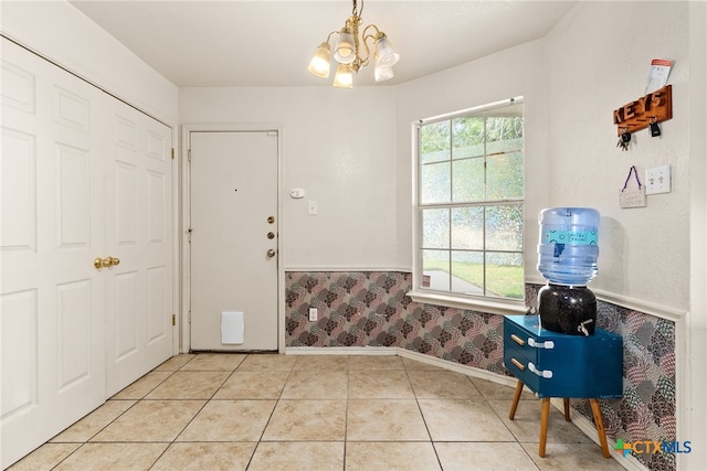 foyer entrance with a chandelier and light tile patterned floors