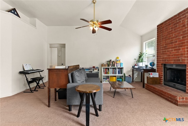 carpeted living room featuring vaulted ceiling, ceiling fan, and a fireplace