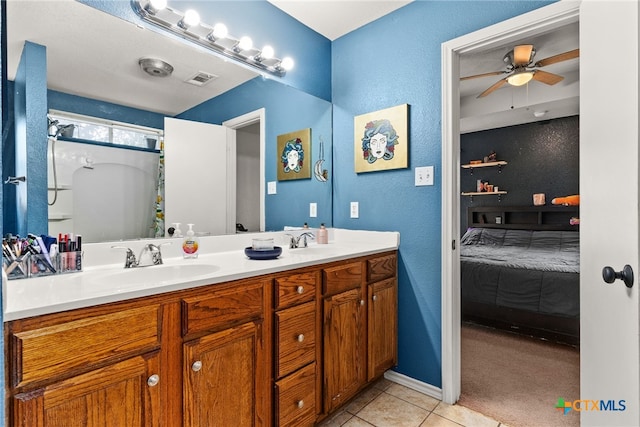 bathroom with walk in shower, tile patterned flooring, vanity, and ceiling fan