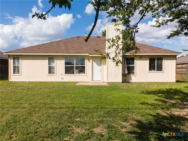 rear view of house with a lawn