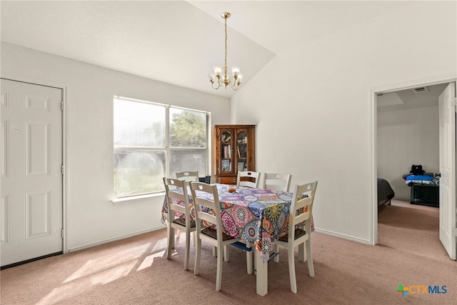 dining room featuring light colored carpet, vaulted ceiling, and a notable chandelier