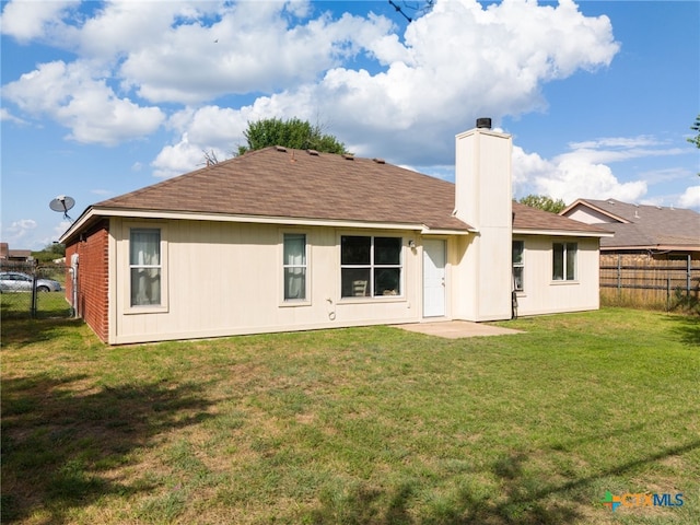 rear view of house with a lawn