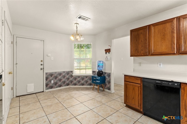 kitchen featuring a chandelier, light tile patterned floors, pendant lighting, and black dishwasher