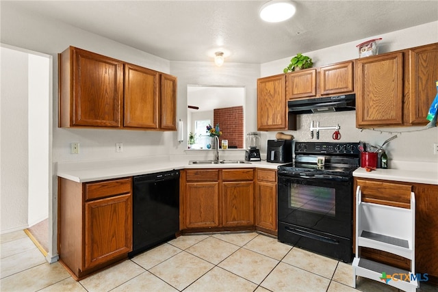 kitchen with black appliances, sink, and light tile patterned floors