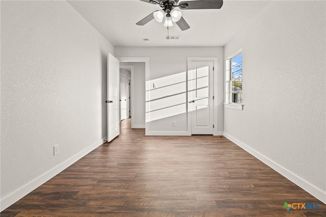 unfurnished bedroom featuring ceiling fan and dark hardwood / wood-style flooring