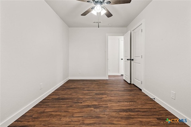 unfurnished room with ceiling fan and dark hardwood / wood-style flooring