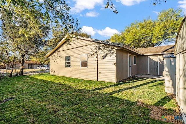 view of home's exterior with a yard