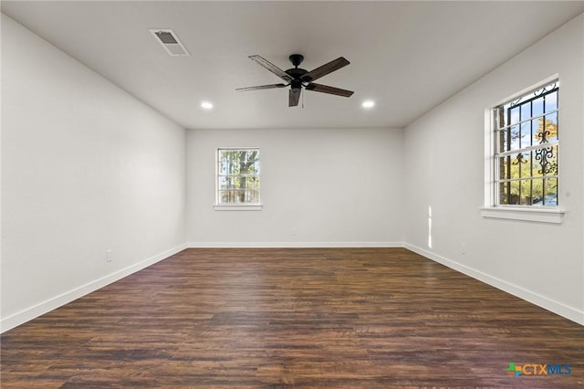 unfurnished room featuring dark hardwood / wood-style floors and ceiling fan