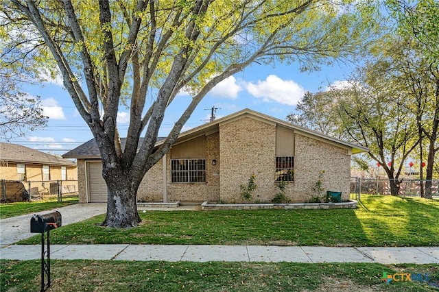 view of front of property featuring a garage and a front lawn