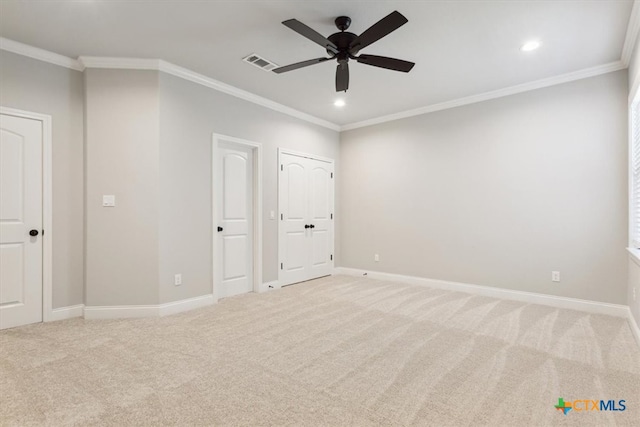 unfurnished bedroom featuring ornamental molding, light carpet, and ceiling fan