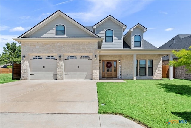 view of front of home with a front lawn and a garage