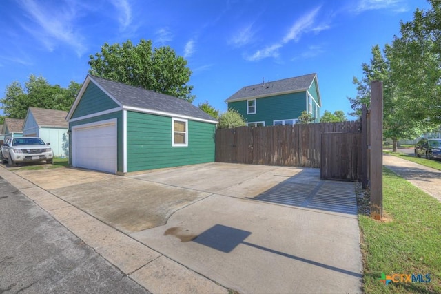 detached garage featuring fence
