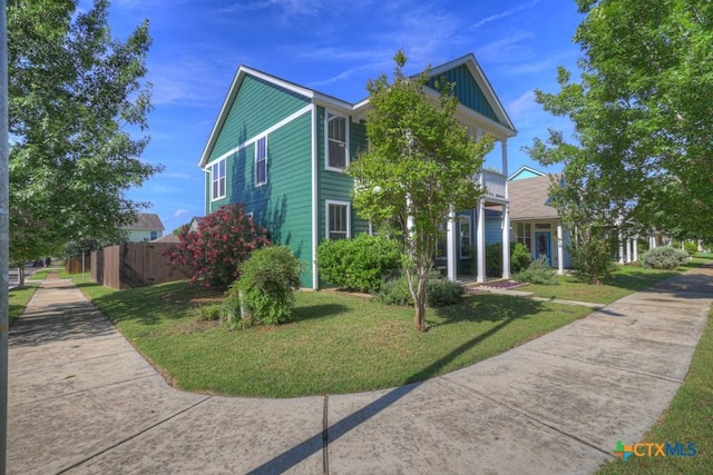 view of home's exterior with fence and a yard