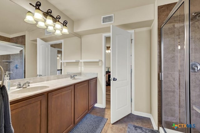full bath featuring double vanity, visible vents, a stall shower, and a sink