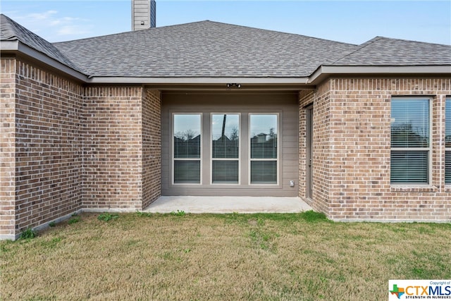 rear view of house with a yard