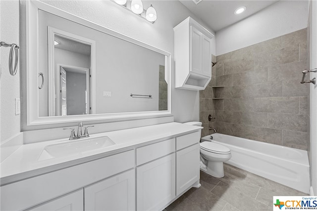 full bathroom featuring toilet, vanity, tiled shower / bath, and tile patterned floors