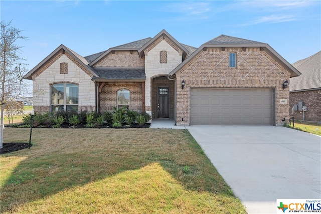 french country home with a garage and a front yard