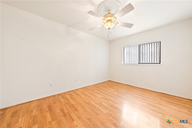 empty room featuring ceiling fan and light hardwood / wood-style flooring