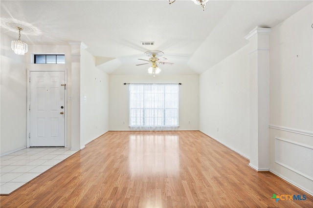 foyer entrance featuring light wood-type flooring, ceiling fan, and decorative columns