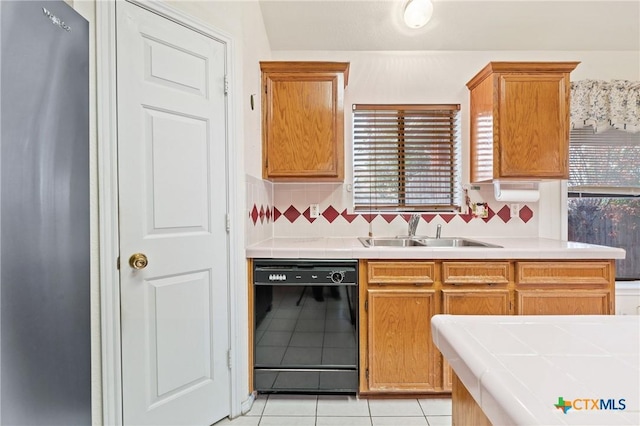 kitchen with sink, dishwasher, plenty of natural light, and backsplash