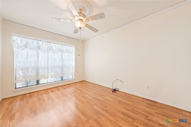 spare room featuring ceiling fan, light hardwood / wood-style flooring, and crown molding