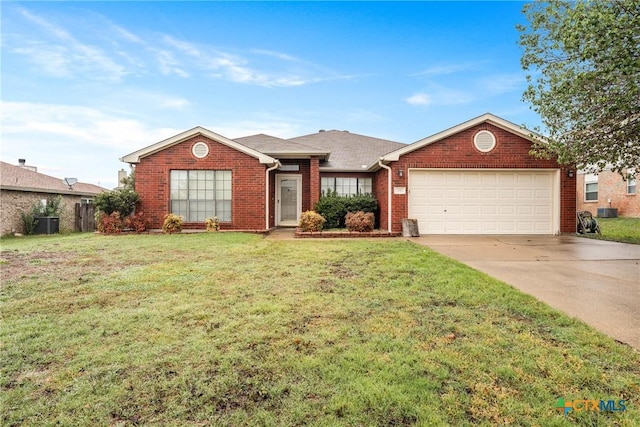 ranch-style home with a garage, cooling unit, and a front yard