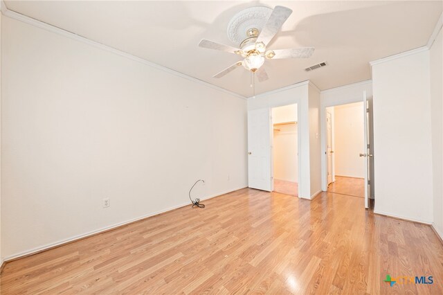 interior space featuring ceiling fan, light hardwood / wood-style flooring, and ornamental molding