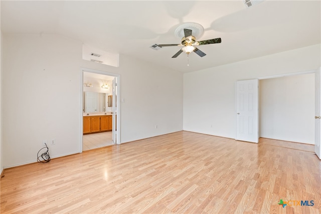 empty room with ceiling fan and light hardwood / wood-style flooring