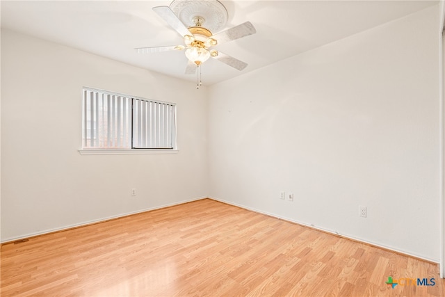 spare room with light wood-type flooring and ceiling fan