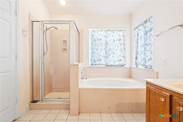 bathroom featuring a healthy amount of sunlight, vanity, tile patterned floors, and shower with separate bathtub