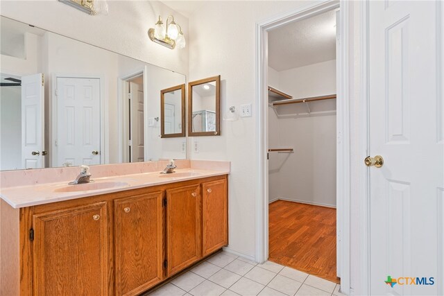 bathroom with vanity, tile patterned floors, and a textured ceiling