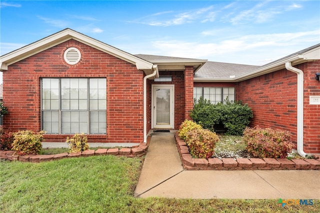 entrance to property with a yard