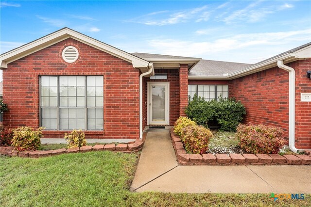 entrance to property with a yard