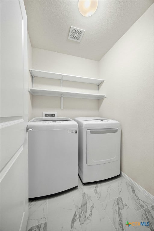324 Brenham Pass, Georgetown, TX 78633 - clothes washing area featuring laundry area, visible vents, marble finish floor, baseboards, and washer and clothes dryer
