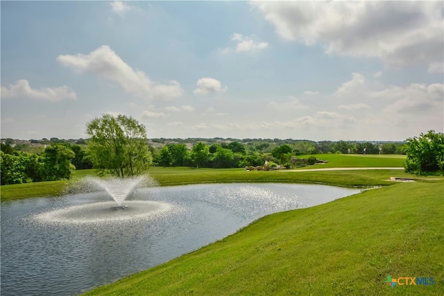 surrounding community featuring a water view and a lawn