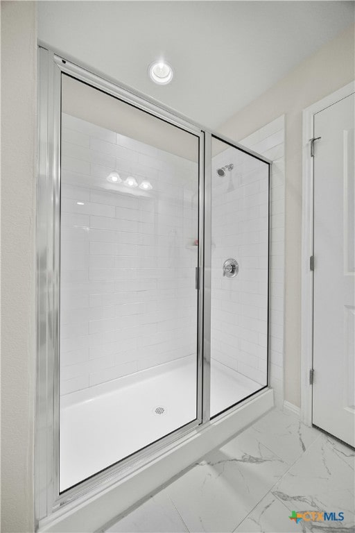 bathroom featuring a shower with shower door