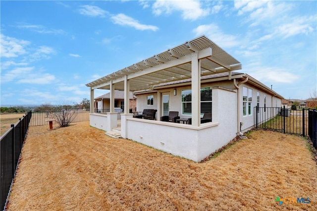 view of side of home featuring a pergola and a patio