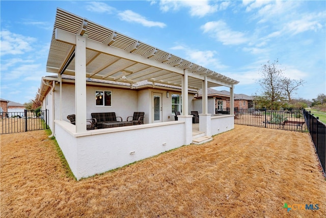 rear view of house with a yard and a pergola