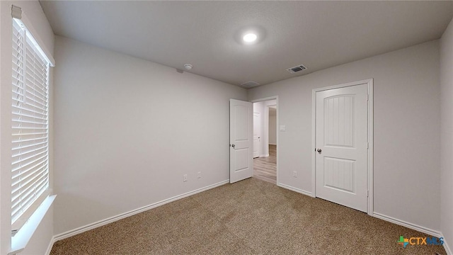 unfurnished bedroom featuring carpet flooring