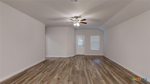 unfurnished room featuring ceiling fan, wood-type flooring, and vaulted ceiling