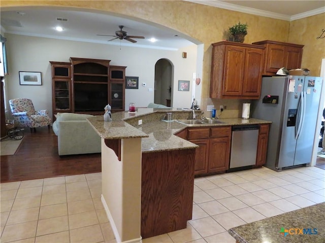 kitchen featuring sink, ceiling fan, stainless steel appliances, ornamental molding, and light tile patterned flooring