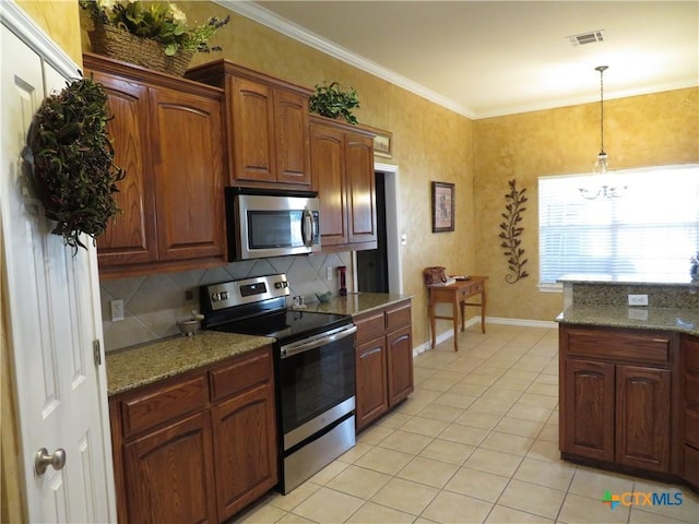 kitchen featuring dark stone countertops, decorative light fixtures, ornamental molding, and appliances with stainless steel finishes