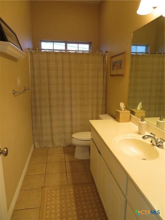 bathroom with a shower with shower curtain, vanity, toilet, and tile patterned flooring