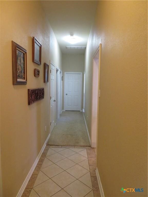 hallway with light tile patterned floors