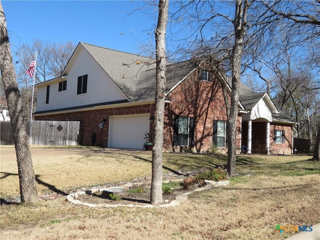 front facade with a garage and a front lawn