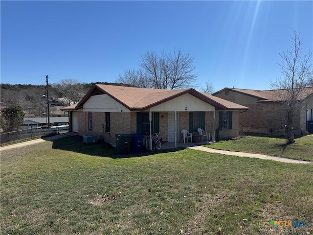 single story home with brick siding, a front lawn, and fence