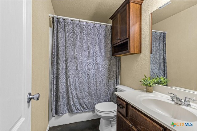 bathroom with toilet, a textured ceiling, vanity, and a textured wall