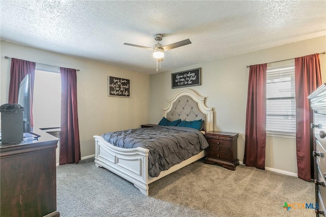 bedroom with carpet floors, baseboards, and a textured ceiling